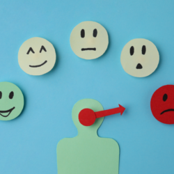 Illustration représentant un profil humain ciblant une émoticône rouge affichant une expression triste parmi d'autres émoticônes aux expressions variées, symbolisant la focalisation sur la tristesse profonde ressentie lors d'épisodes dépressifs, en lien avec l'article sur la dépression. Dynabiane et dépression Analyse de l'efficacité du remède naturel du laboratoire PiLeJe